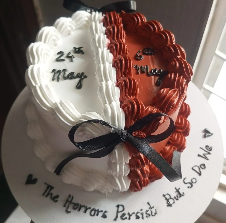 Piping a birthday message onto a cake with a small round tip